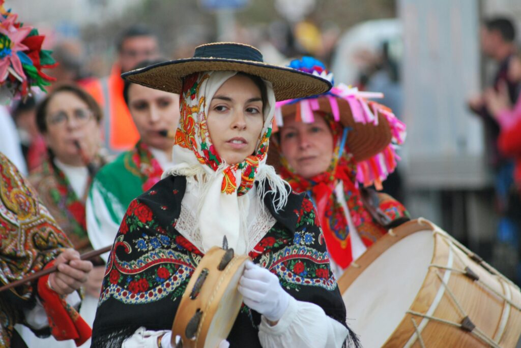 Women in colorful traditional costumes participate in a vibrant cultural parade.