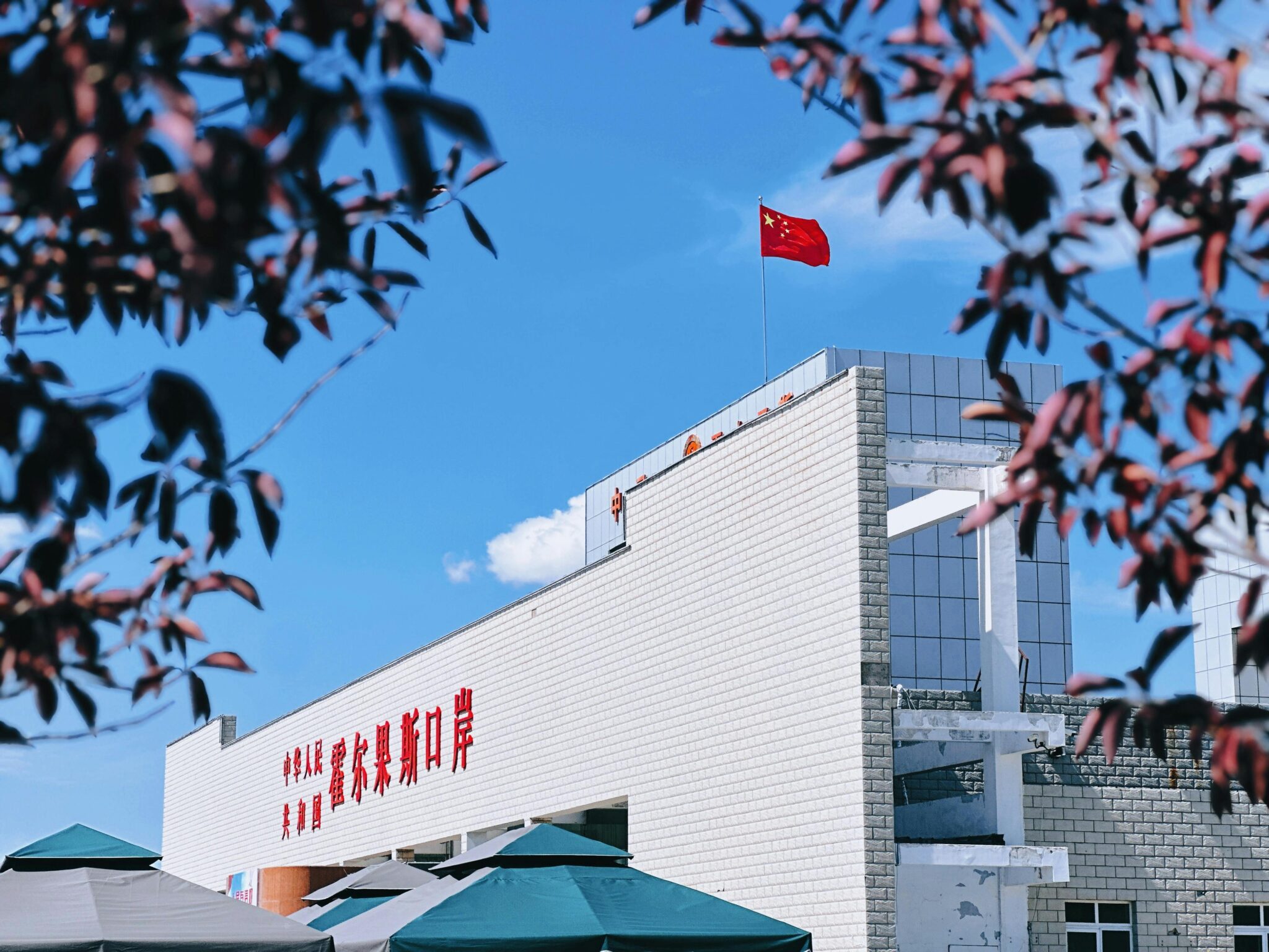 A view of Korghos Port featuring the Chinese flag on a sunny day.